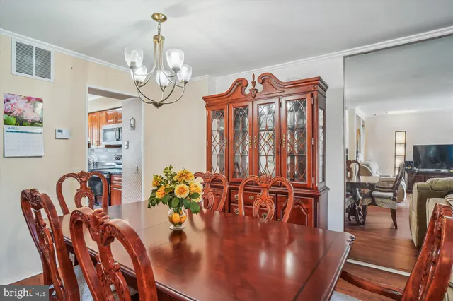 a kitchen with stainless steel appliances granite countertop a sink a stove and a wooden floors