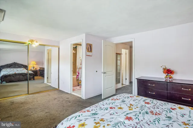 a bedroom with a bed and dresser