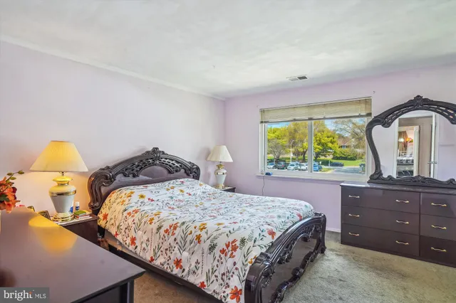 a bedroom with a bed and a dresser