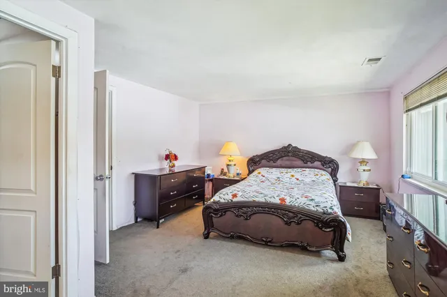 a bedroom that has a bed and a chair in it