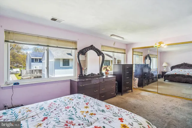 a bedroom with a bed and glass door