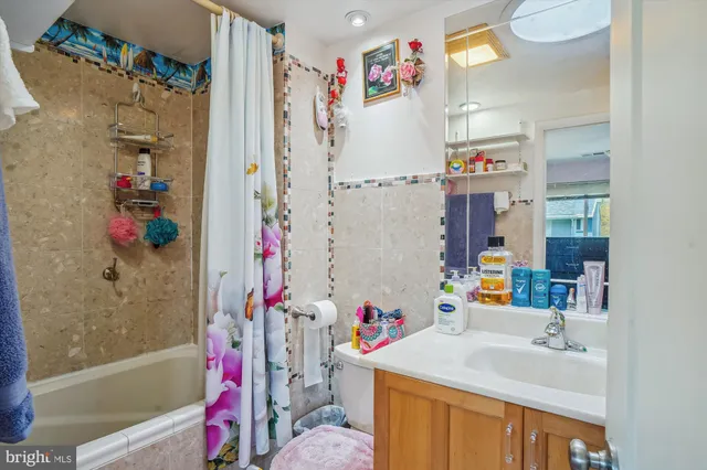 a bathroom with a sink vanity mirror and toilet