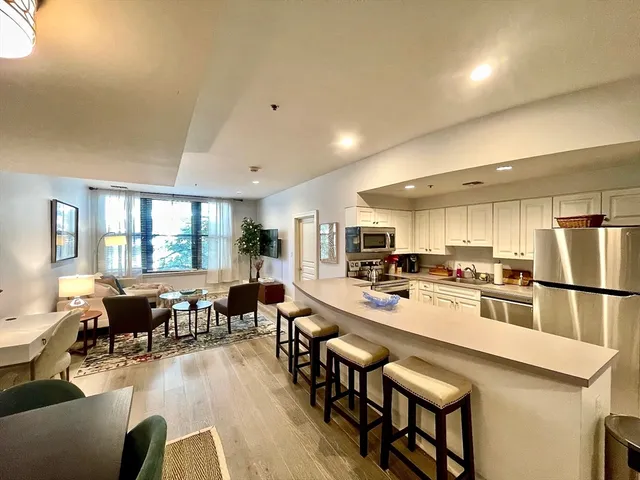 a large kitchen with a table and chairs