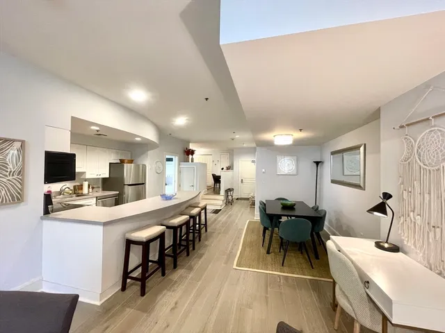 a room with stainless steel appliances lots of counter top space and furniture