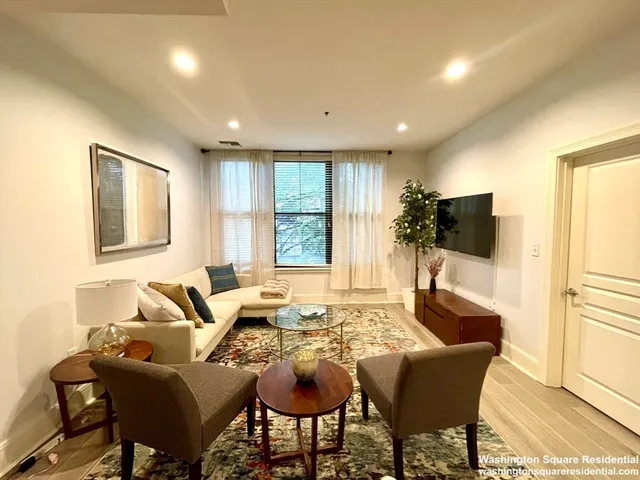 a living room with furniture and a rug