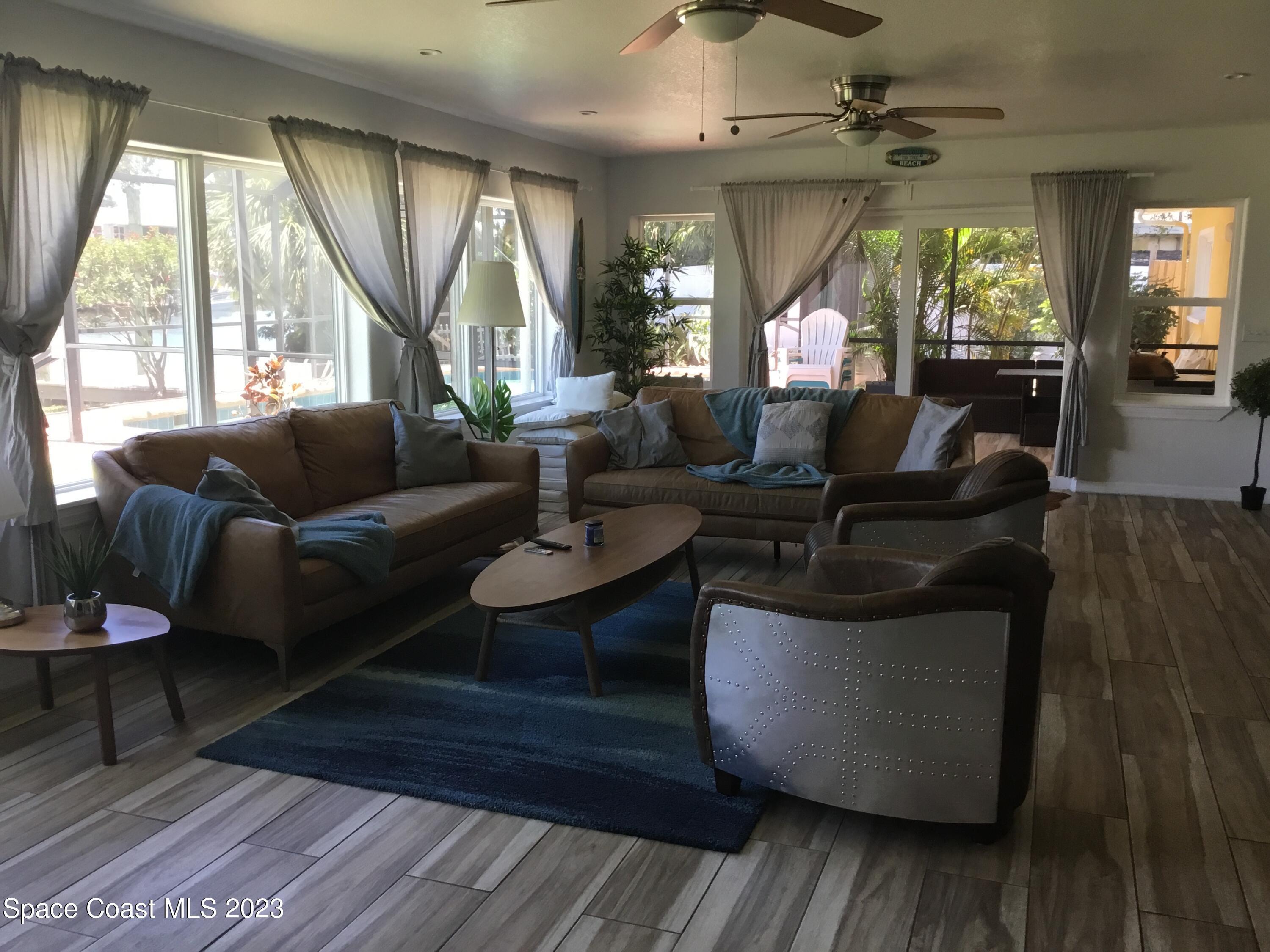453 Capri Road Cocoa Beach, FL 32931 - Photo 18 of 30 a living room with furniture and a large window