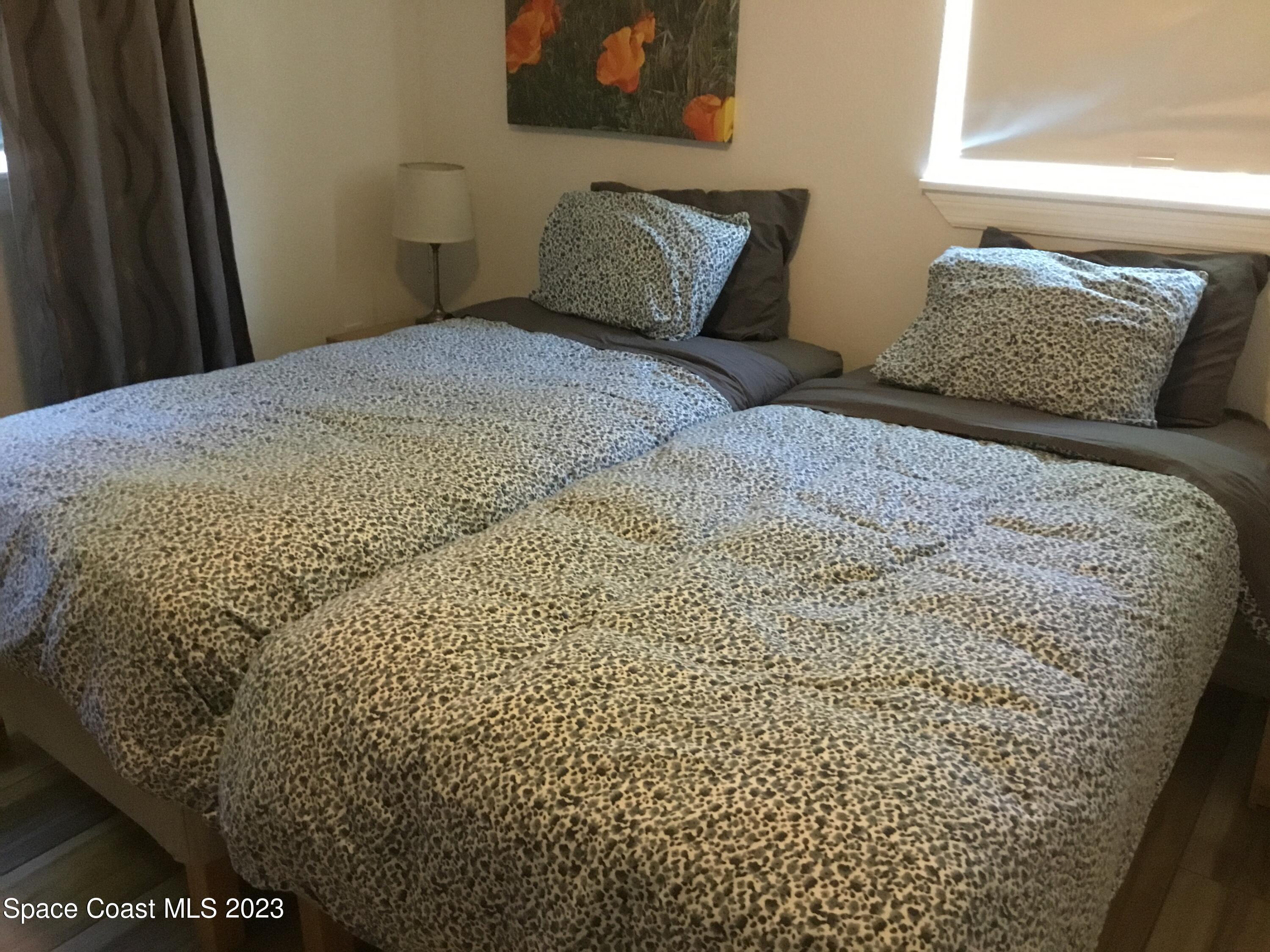 453 Capri Road Cocoa Beach, FL 32931 - Photo 28 of 30 a bedroom with a bed and a window