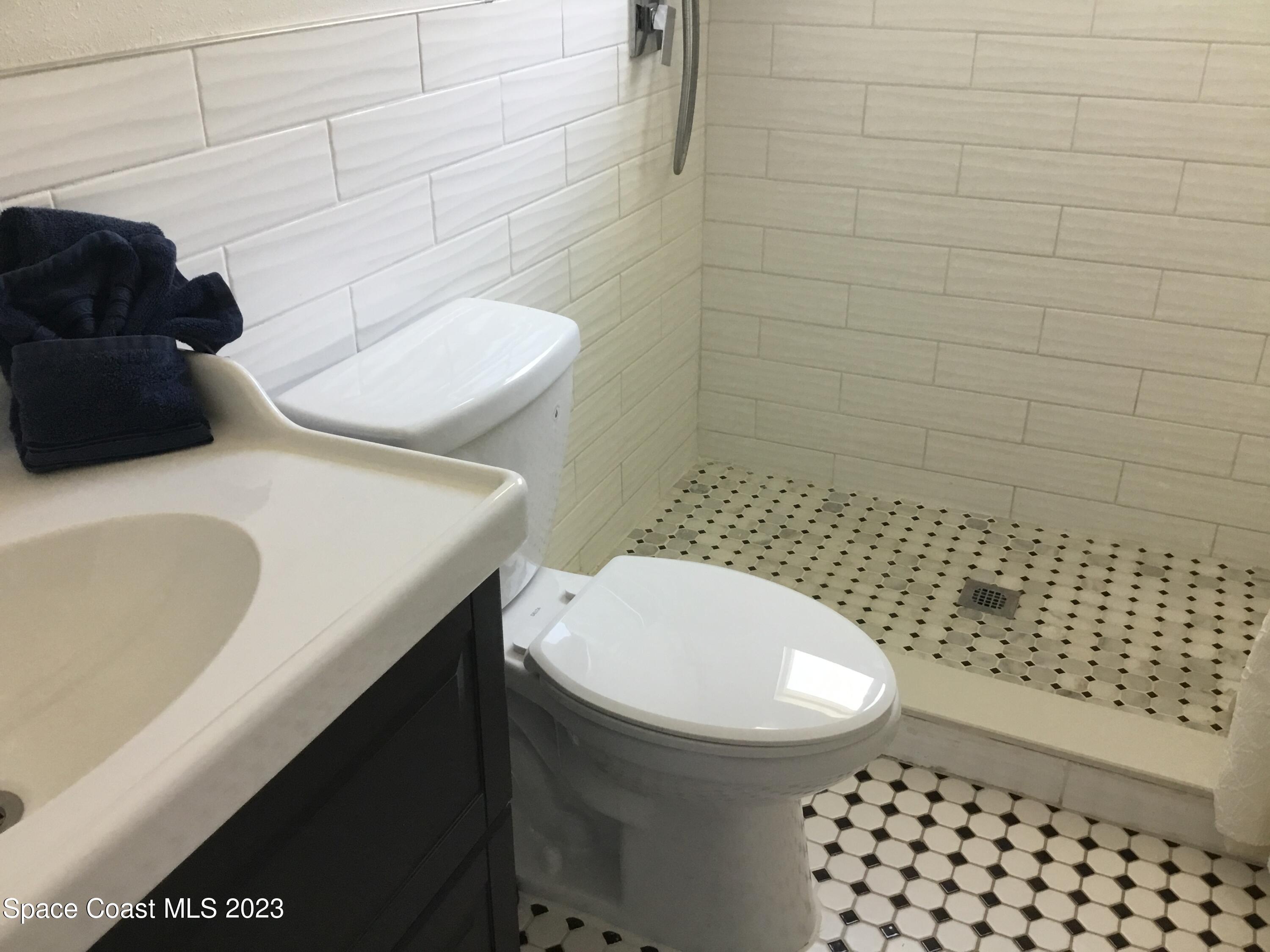 453 Capri Road Cocoa Beach, FL 32931 - Photo 30 of 30 a bathroom with a sink toilet and shower