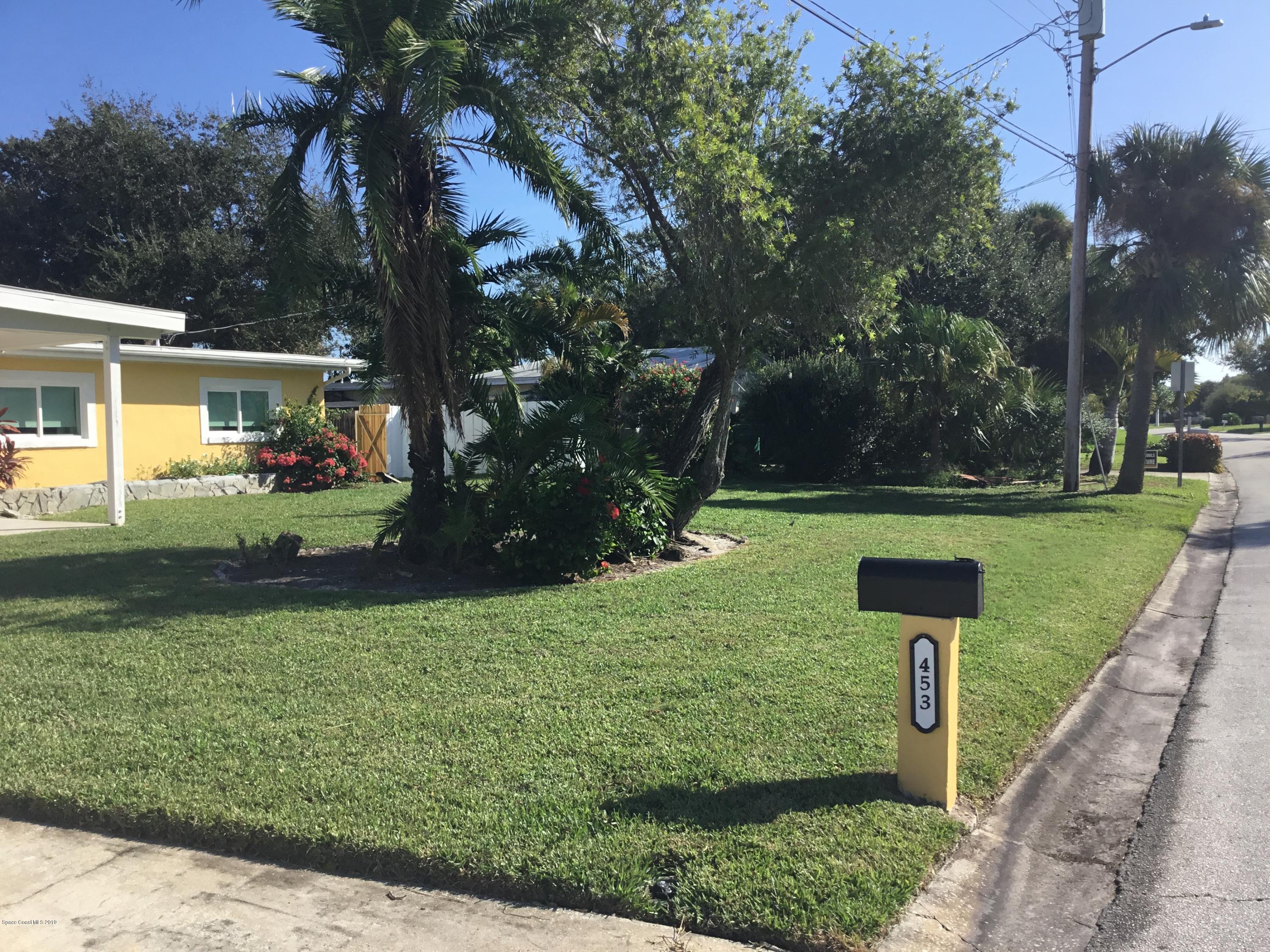 453 Capri Road Cocoa Beach, FL 32931 - Photo 3 of 30 front view of a house with a yard