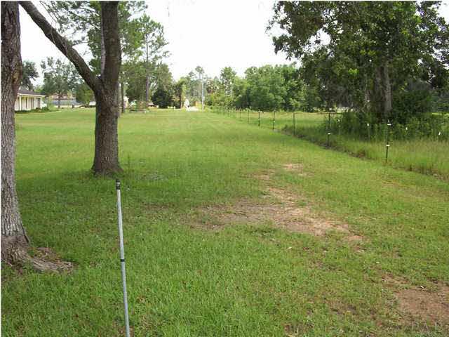 Looking back from same NE Corner towards 9 MILE Road. Metal stake marks line. Huge space (.25 acres) between this 2.28 Parcel and the neighboring brick home.