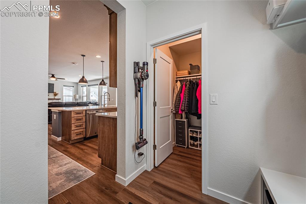 11148 Cloud Shadow Road Littleton, CO 80125 - Photo 14 of 46 a view of a hallway with wooden floor and staircase