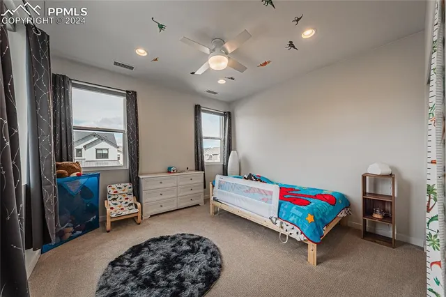 a bedroom with furniture and a large window