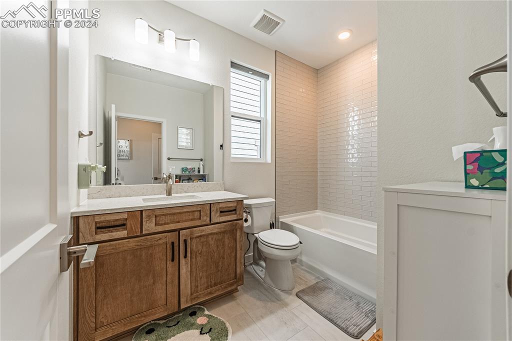 11148 Cloud Shadow Road Littleton, CO 80125 - Photo 22 of 46 a spacious bathroom with a granite countertop toilet sink and mirror