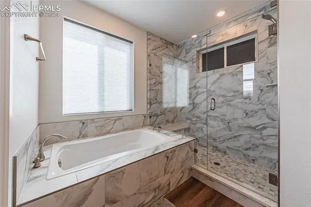 a bath tub sitting in a bathroom next to a window