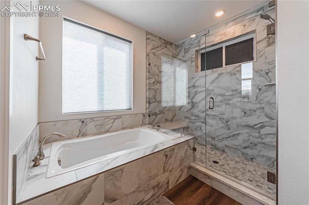 11148 Cloud Shadow Road Littleton, CO 80125 - Photo 30 of 46 a bathroom with a bathtub and a shower