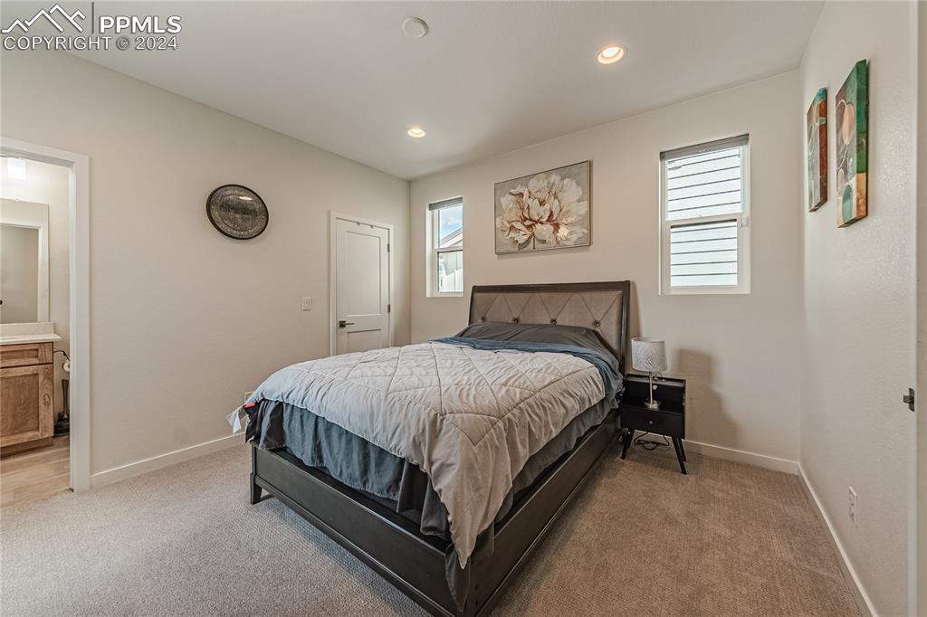 11148 Cloud Shadow Road Littleton, CO 80125 - Photo 3 of 46 a bed sitting in a bedroom next to a window