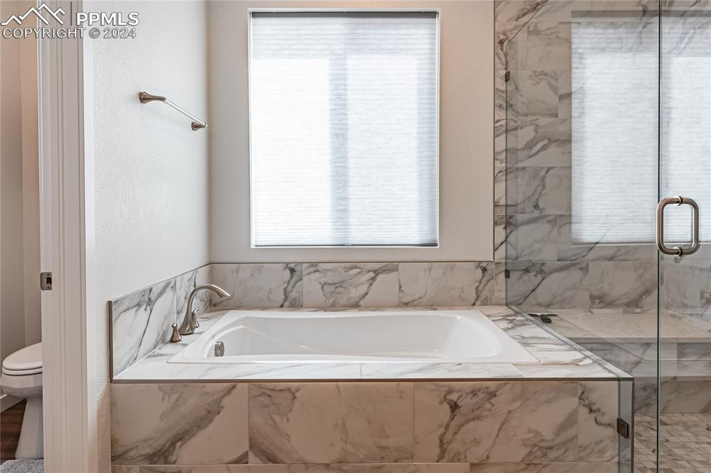11148 Cloud Shadow Road Littleton, CO 80125 - Photo 31 of 46 a bath tub sitting in a bathroom next to a window
