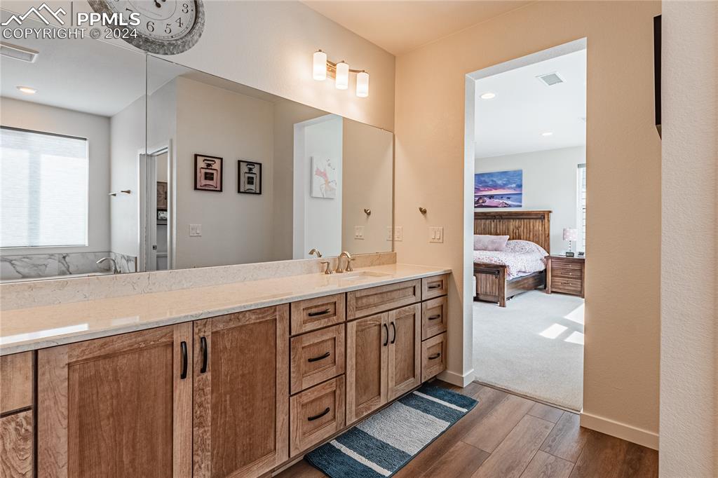 11148 Cloud Shadow Road Littleton, CO 80125 - Photo 33 of 46 a spacious bathroom with a double vanity sink and a mirror