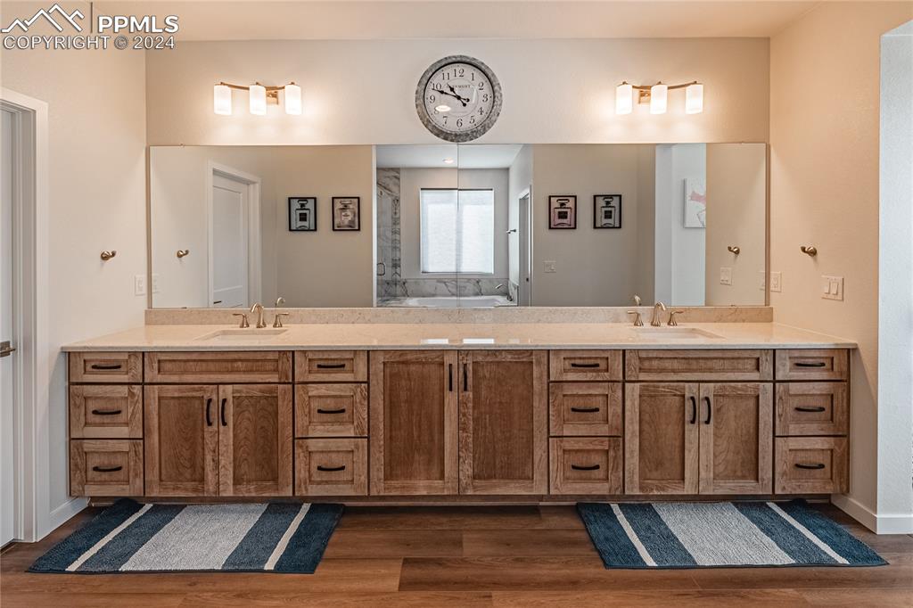 11148 Cloud Shadow Road Littleton, CO 80125 - Photo 35 of 46 a bathroom with a sink vanity and a large mirror