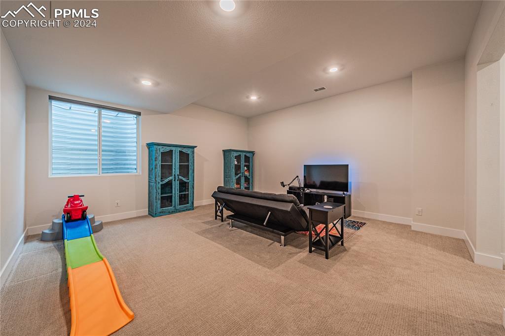 11148 Cloud Shadow Road Littleton, CO 80125 - Photo 38 of 46 a living room with furniture and a flat screen tv