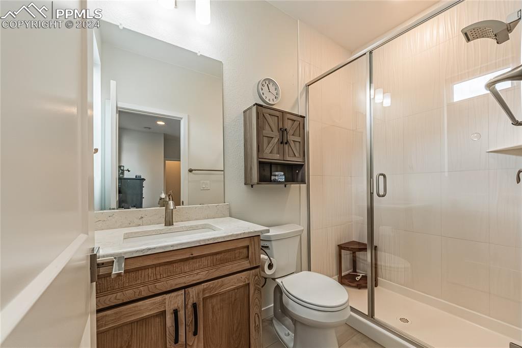 11148 Cloud Shadow Road Littleton, CO 80125 - Photo 4 of 46 a bathroom with a sink toilet vanity and shower