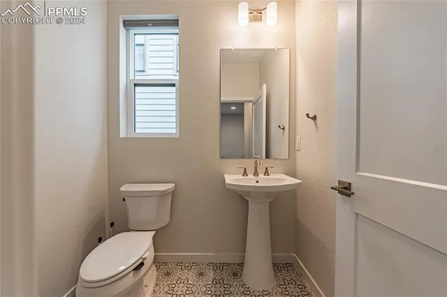 a white toilet sitting next to a bathroom sink