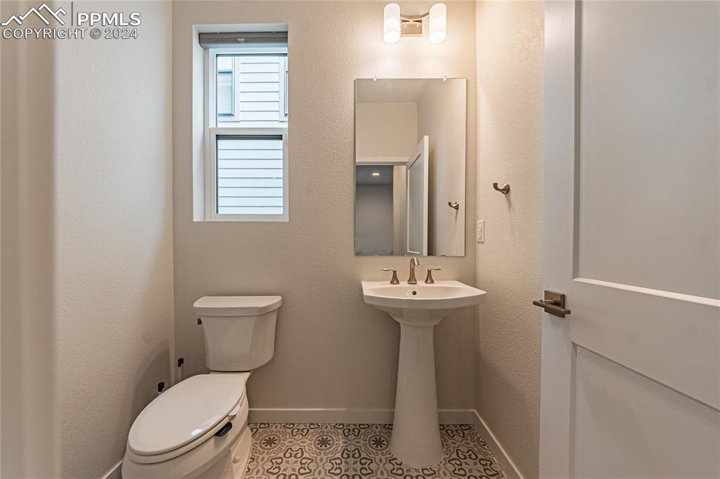 11148 Cloud Shadow Road Littleton, CO 80125 - Photo 5 of 46 a white toilet sitting next to a bathroom sink
