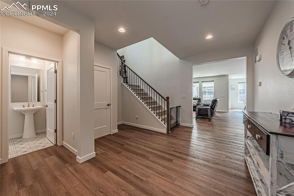 11148 Cloud Shadow Road Littleton, CO 80125 - Photo 7 of 46 a view of a hallway view with wooden floor and staircase