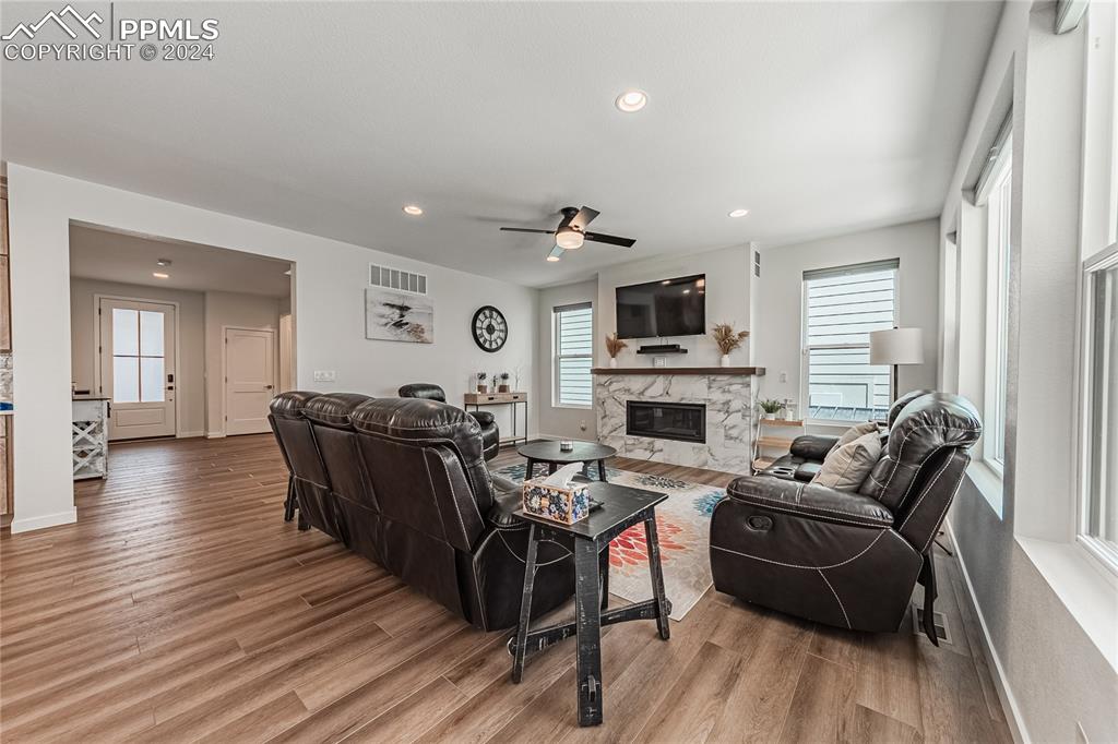 11148 Cloud Shadow Road Littleton, CO 80125 - Photo 8 of 46 a living room with furniture a fireplace and a flat screen tv
