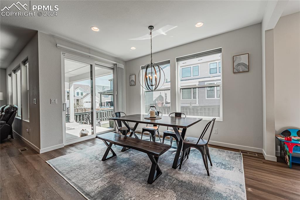 11148 Cloud Shadow Road Littleton, CO 80125 - Photo 9 of 46 a view of a dining room with furniture window and wooden floor