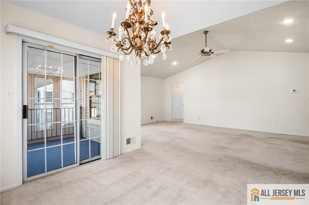 11A Rothwell Drive, Unit 11D Monroe Township, NJ 08831 - Photo 13 of 43 en empty room with windows and ceiling fan