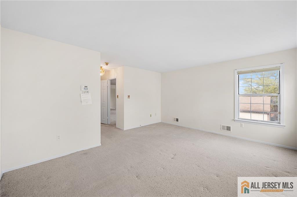 11A Rothwell Drive, Unit 11D Monroe Township, NJ 08831 - Photo 18 of 43 an empty room with windows and closet