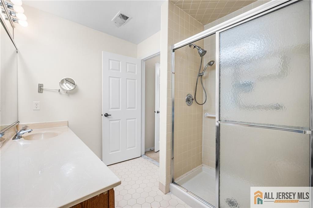 11A Rothwell Drive, Unit 11D Monroe Township, NJ 08831 - Photo 21 of 43 a bathroom with a shower and a sink