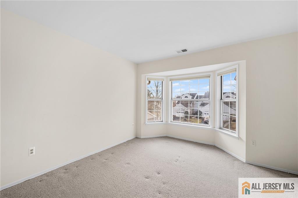11A Rothwell Drive, Unit 11D Monroe Township, NJ 08831 - Photo 22 of 43 an empty room with windows