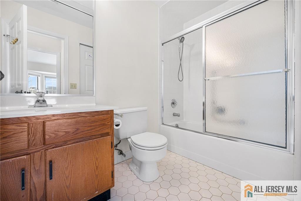 11A Rothwell Drive, Unit 11D Monroe Township, NJ 08831 - Photo 26 of 43 a bathroom with a granite countertop sink toilet and shower