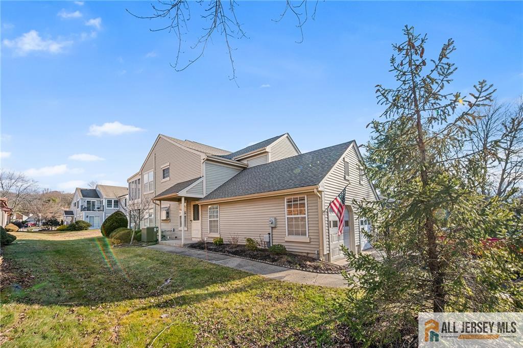 11A Rothwell Drive, Unit 11D Monroe Township, NJ 08831 - Photo 3 of 43 a view of a big house with a big yard and large tree