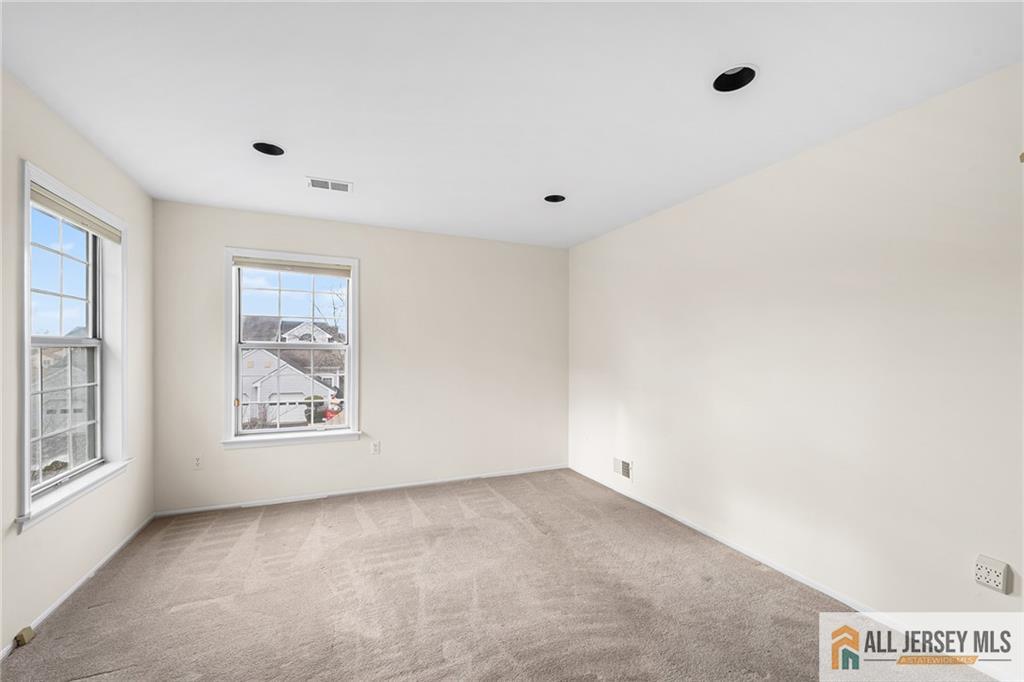 11A Rothwell Drive, Unit 11D Monroe Township, NJ 08831 - Photo 7 of 43 an empty room with windows
