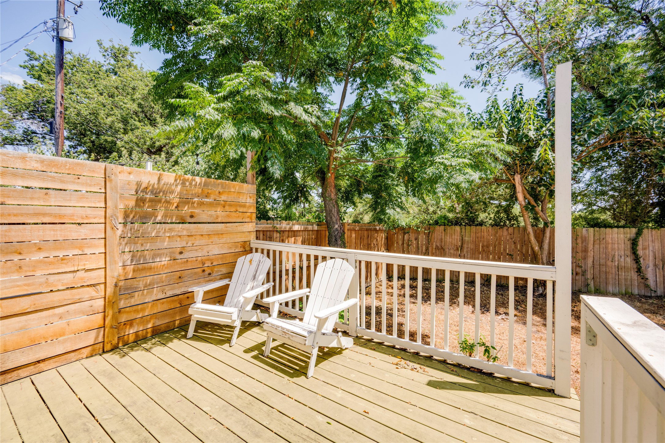 1400 Marcus Place, Unit B Austin, TX 78721 - Photo 32 of 39 Relax on the ample deck, enclosed by a privacy fence, offering a verdant outdoor space.