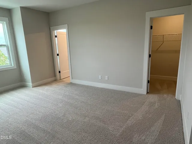 an empty room with windows and entrance