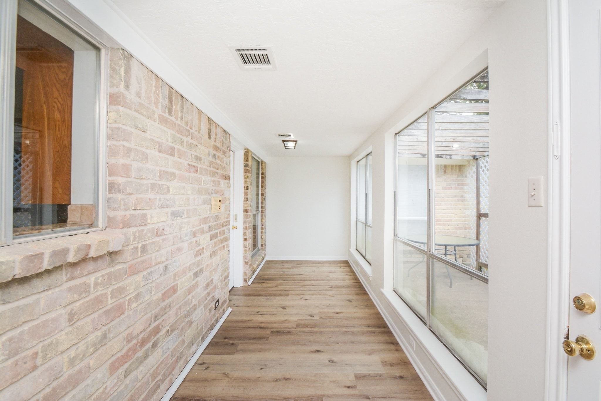 10811 Vickijohn Court Houston, TX 77071 - Photo 17 of 20 a view of a hallway with wooden floor and staircase