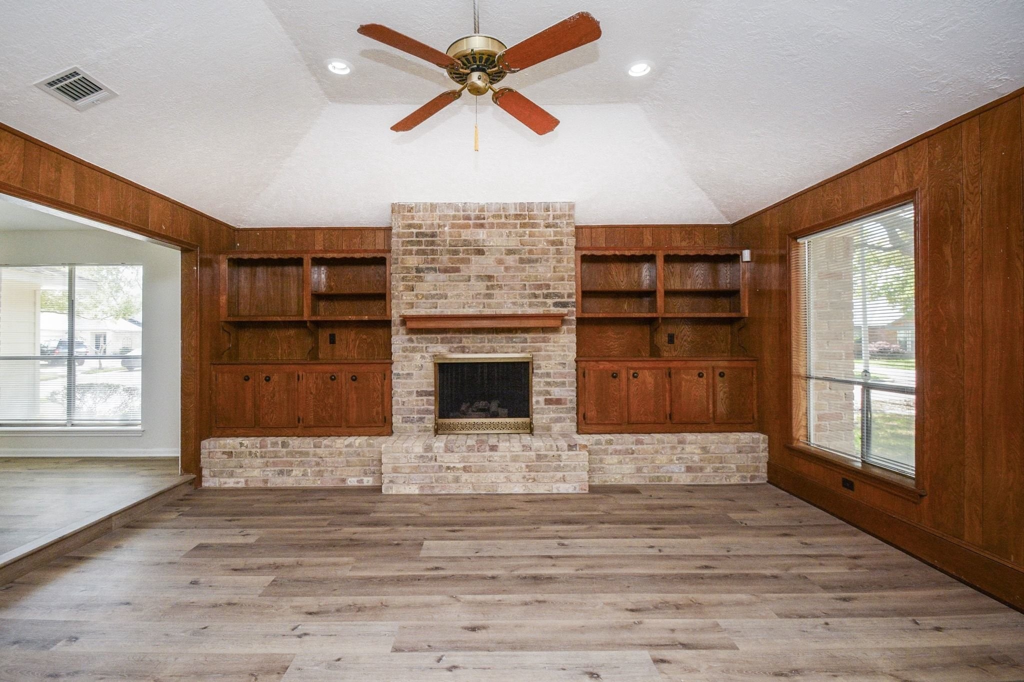 10811 Vickijohn Court Houston, TX 77071 - Photo 2 of 20 a view of a livingroom with a fireplace a ceiling fan and window