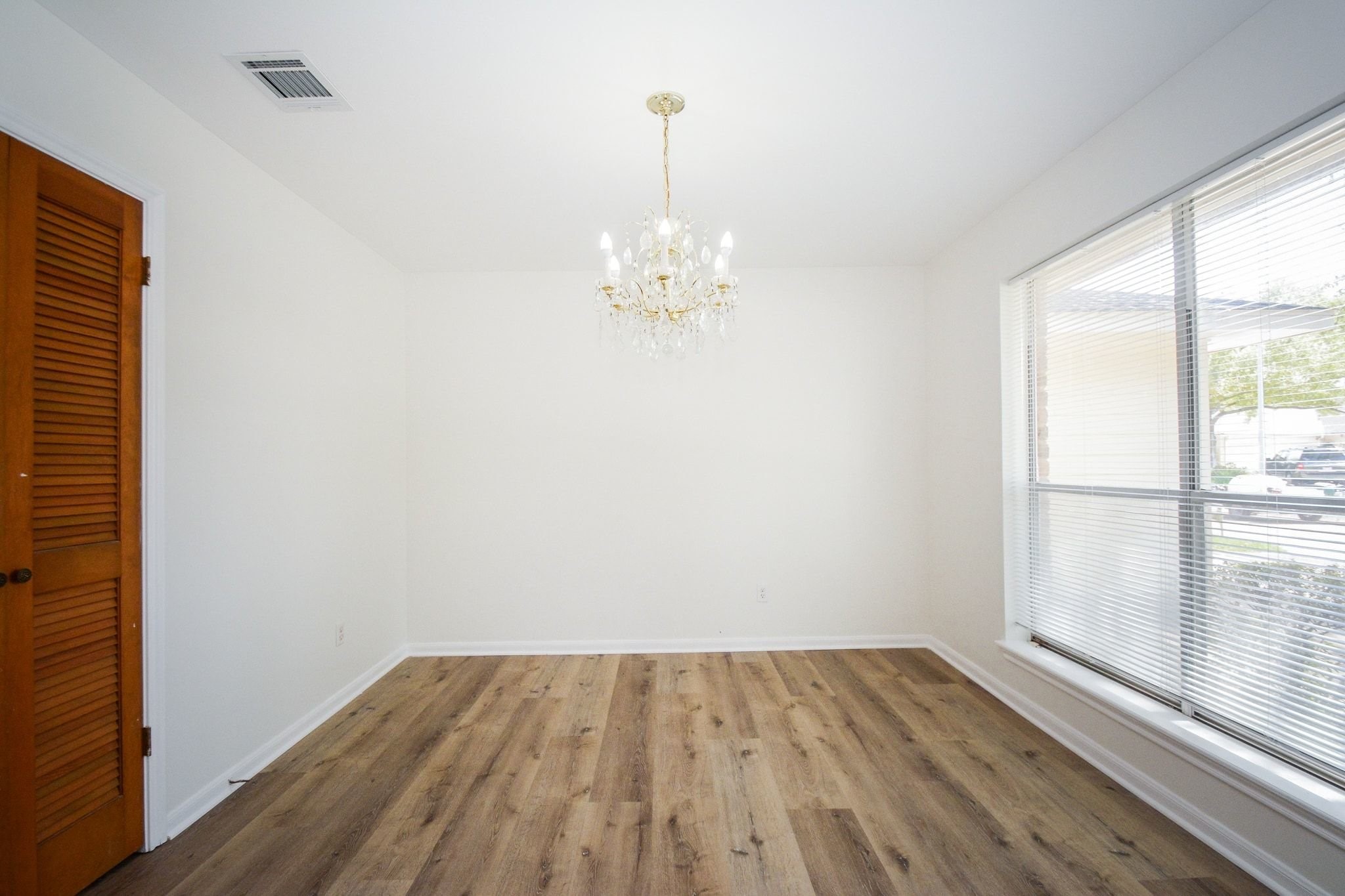 10811 Vickijohn Court Houston, TX 77071 - Photo 5 of 20 wooden floor in an empty room with a window
