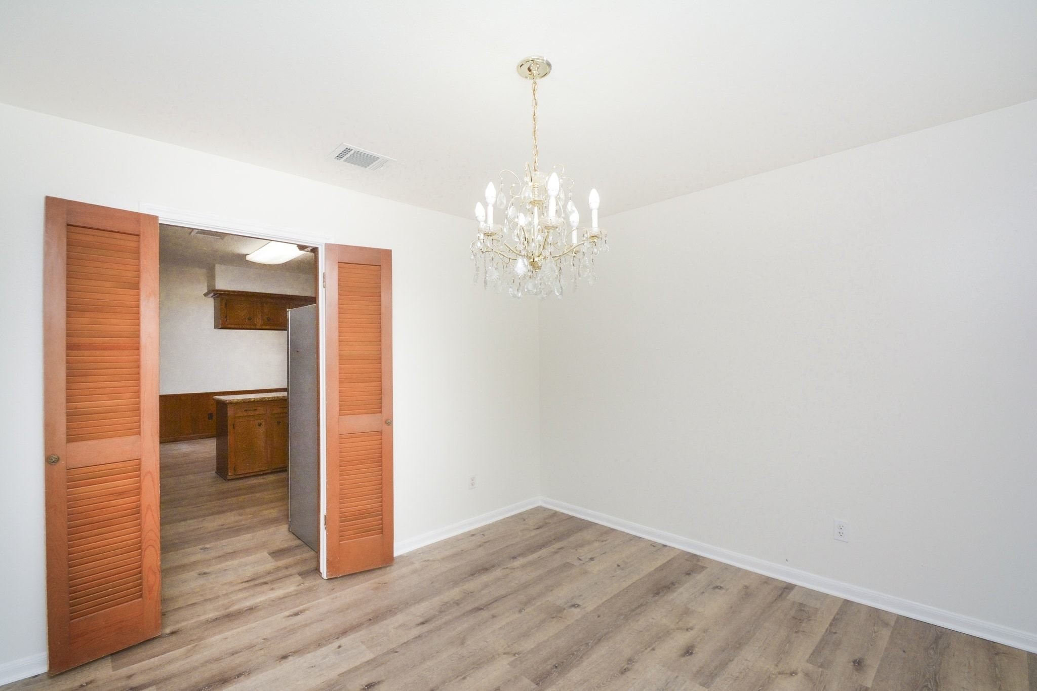 10811 Vickijohn Court Houston, TX 77071 - Photo 6 of 20 a very nice looking room with wooden floor and chandelier