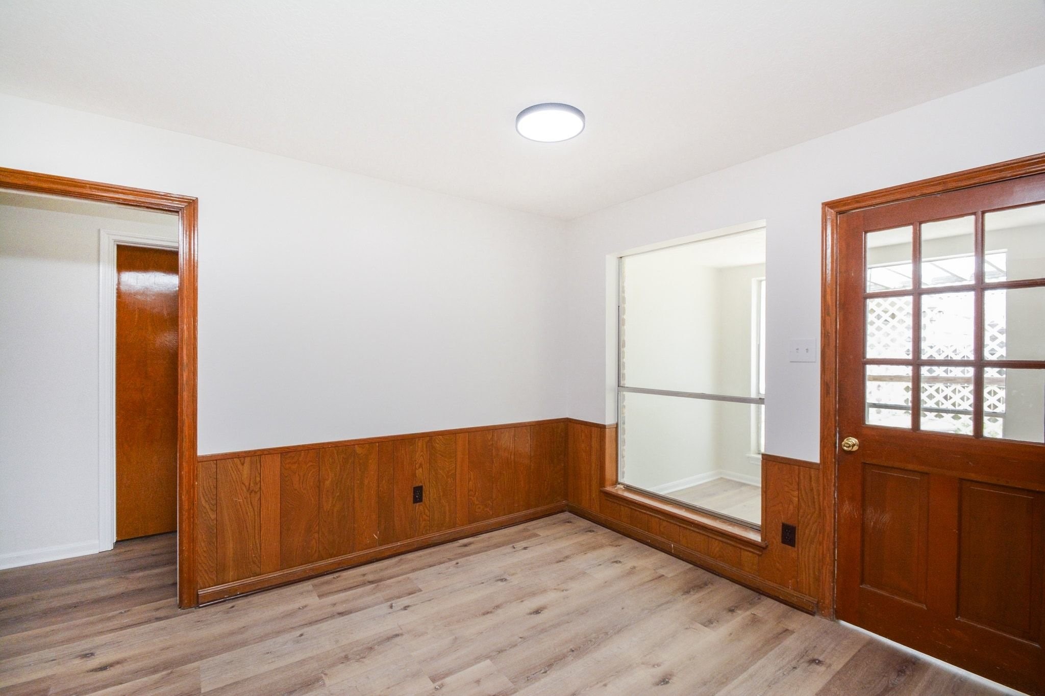 10811 Vickijohn Court Houston, TX 77071 - Photo 10 of 20 an empty room with wooden floor and windows