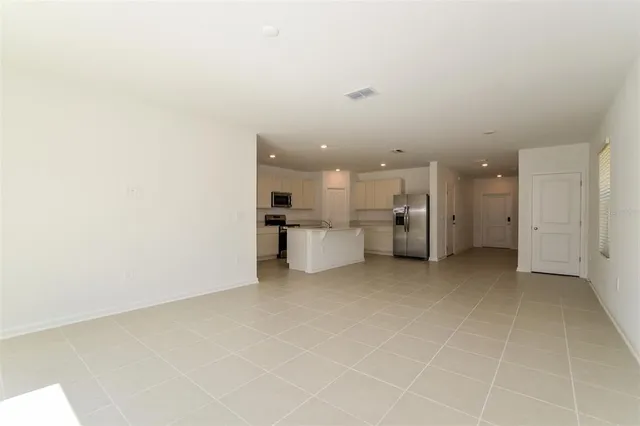 a view of a kitchen with a sink and a refrigerator