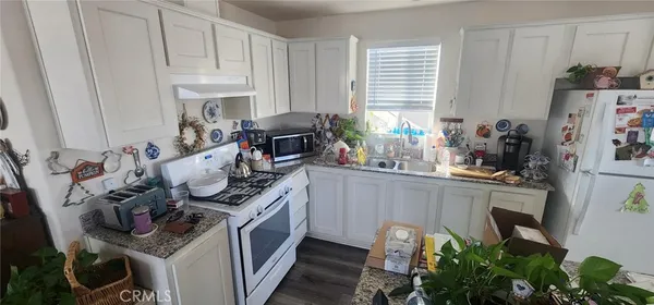 a kitchen with stainless steel appliances granite countertop a sink stove and cabinets