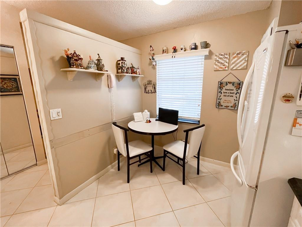 8673 Sunbird Place Boca Raton, FL 33496 - Photo 4 of 28 a dining room with furniture and a window