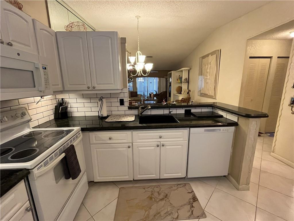 8673 Sunbird Place Boca Raton, FL 33496 - Photo 6 of 28 a kitchen with a sink cabinets and window