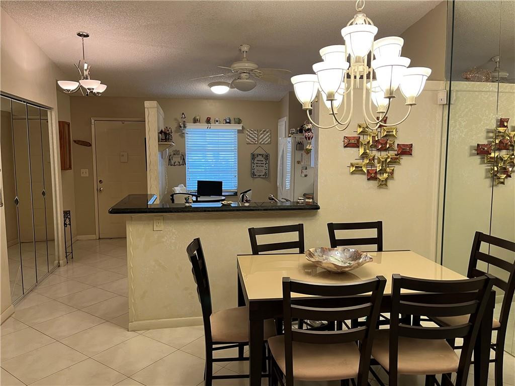 8673 Sunbird Place Boca Raton, FL 33496 - Photo 7 of 28 a view of a dining room with furniture and chandelier