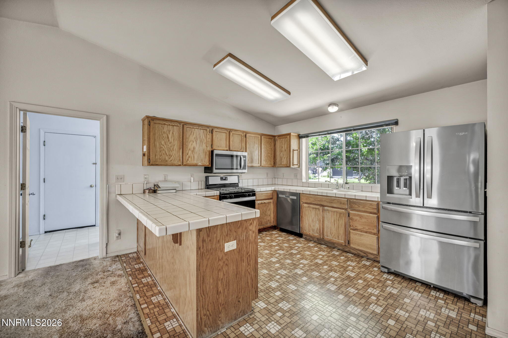 692 Lassen Way Gardnerville, NV 89460 - Photo 10 of 34 a kitchen with a stove a refrigerator and a sink